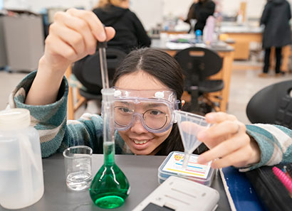 Female student doing chemistry experiment