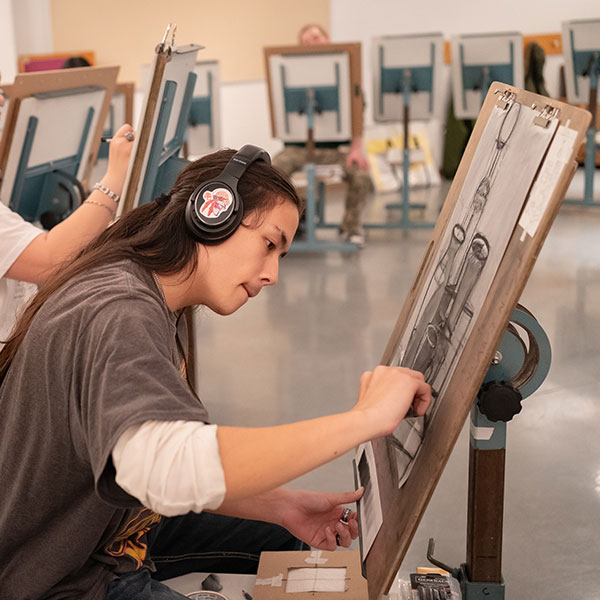 Student drawing in art class