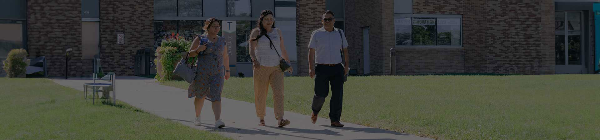 Three students walking outside the campus
