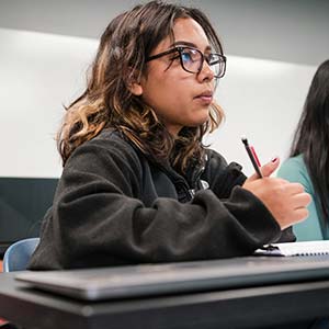 Female student taking notes in class