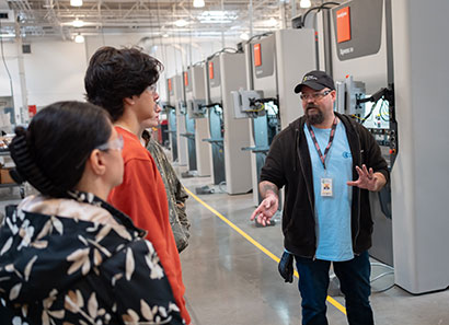Open house attendees on tour of welding lab, ATC open house