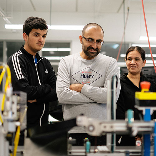 Open house attendees viewing high-tech machinery at ATC in Gurnee