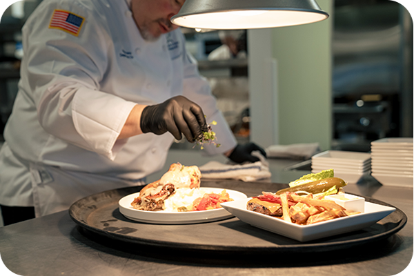 A chef at the Prairie at Brae Loch Restaurant preparing food