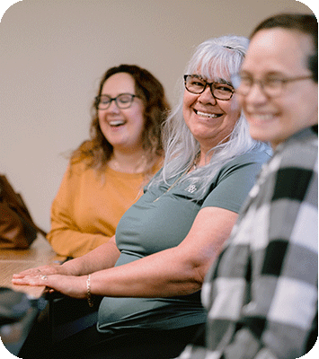 Adult students smiling in a class
