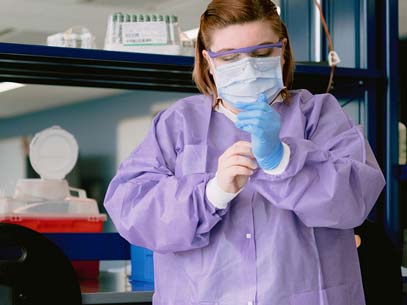 Students puts on latex gloves