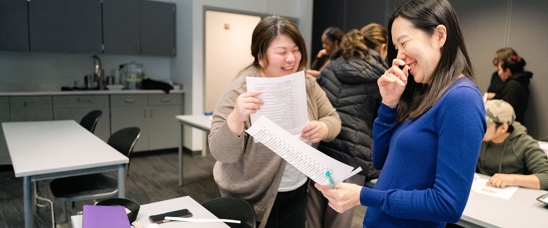Smiling students participating in free ESL classes at College of Lake County