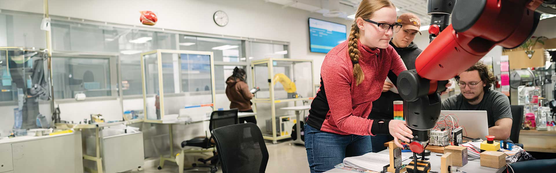 Students working with robot in lab