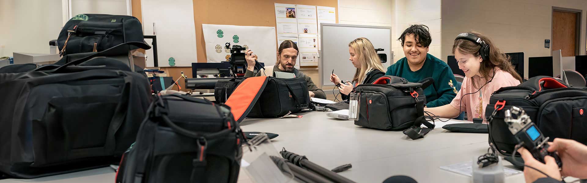 Students learning hands-on in digital media class.