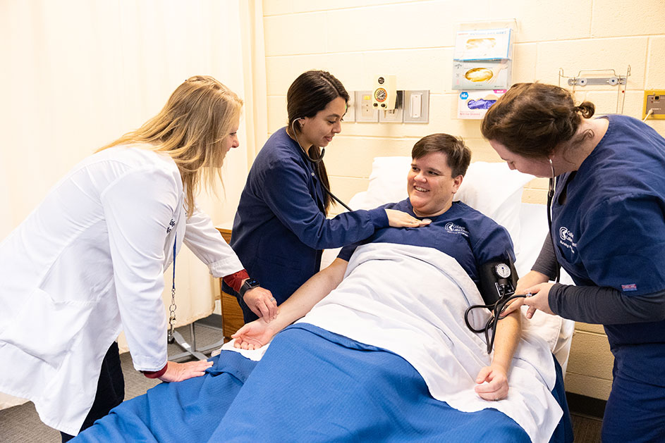 Nursing students practicing hands on in the lab