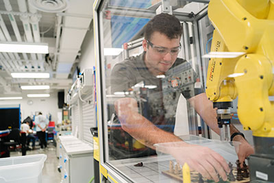 Student working on high-tech manufacturing equipment