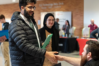 Students meeting employer at campus job fair