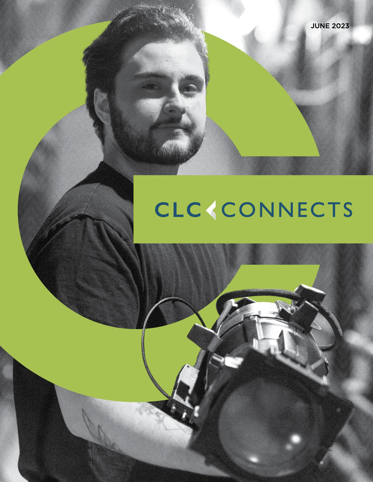 Magazine cover image of student holding stage lighting equipment