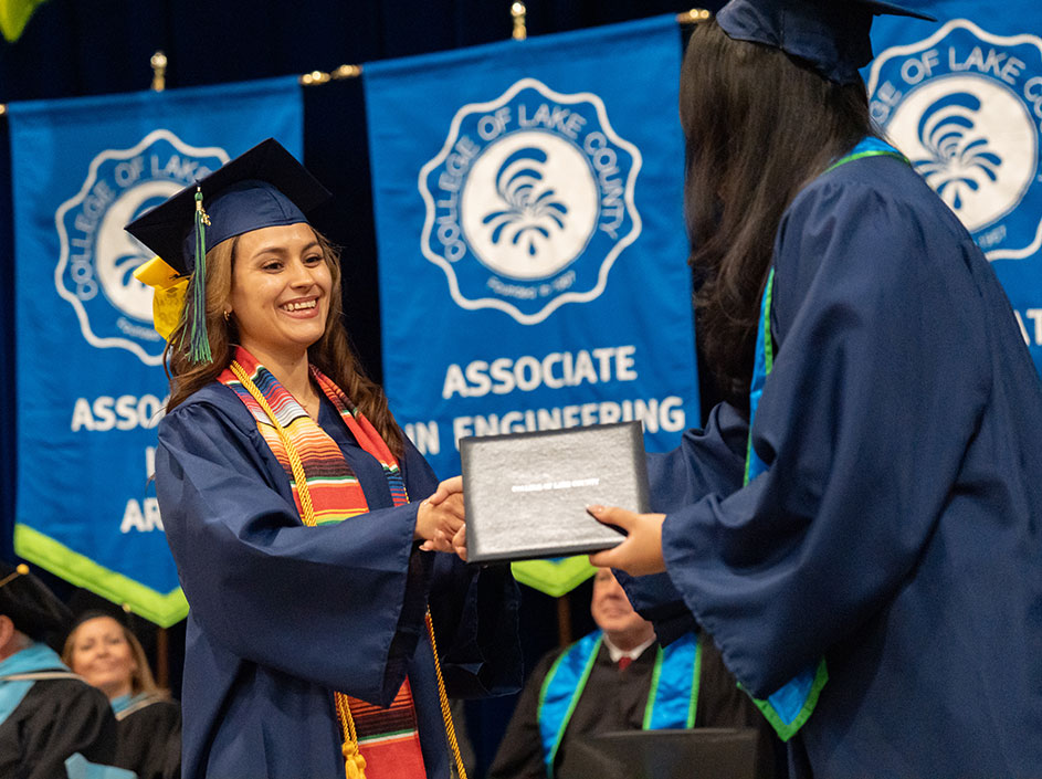Student receiving her diploma at commencement ceremony