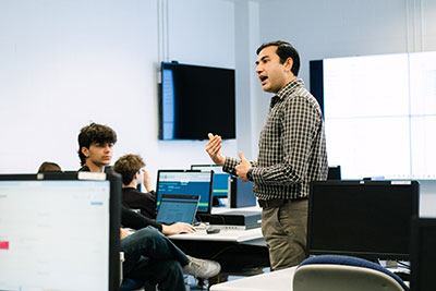 Instructor speaking to students in classroom