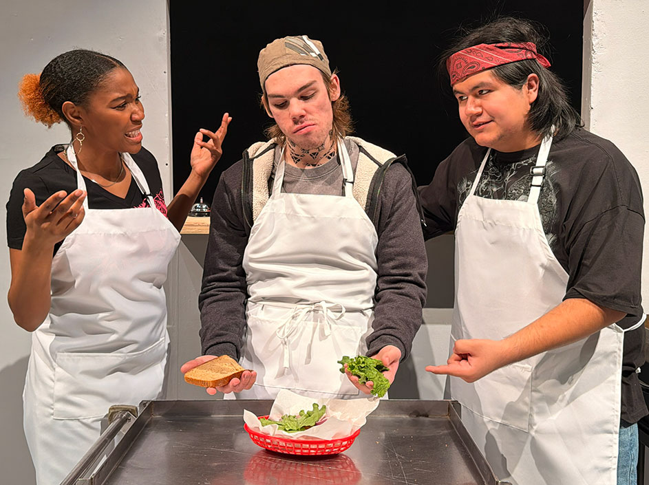 Students acting in a scene from the play Clyde's