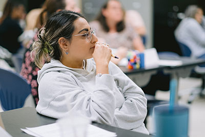 Female student listening in education class