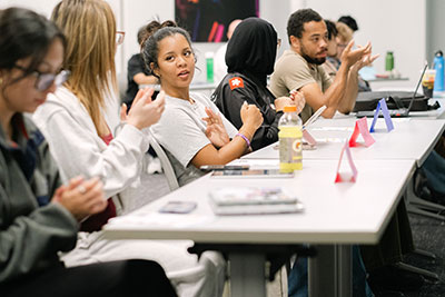Students involved in student government sit at a long table