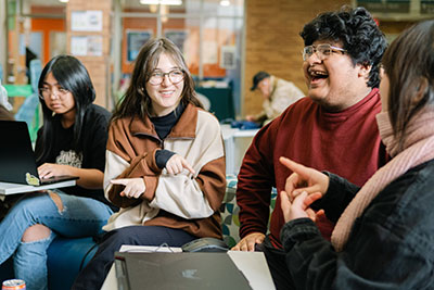 Group of students laughing during a break between classes