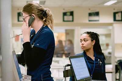 Two nursing students taking direction