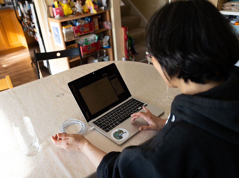 Student writing on their laptop