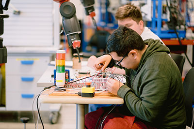 Students in mechatronics lab working on project