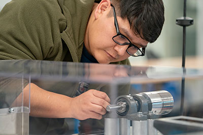 Student looking closely at motor control