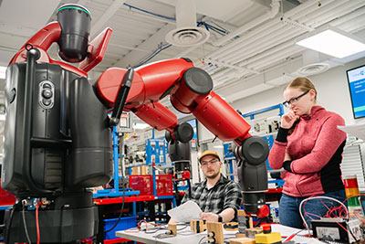Students troubleshooting with a robot