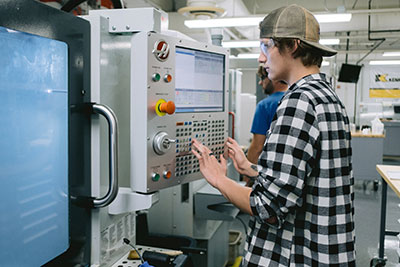 Student programming a CNC machine