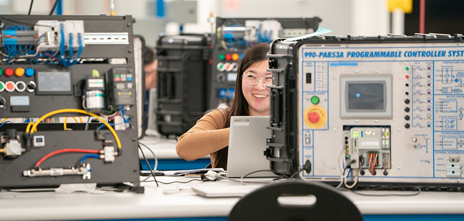 Female student smiling in Industrial Technology lab