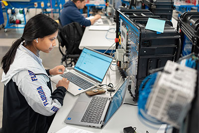 Student working on software in manufacturing environment