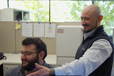Travis Taylor and Juan Martinez discussing a work project