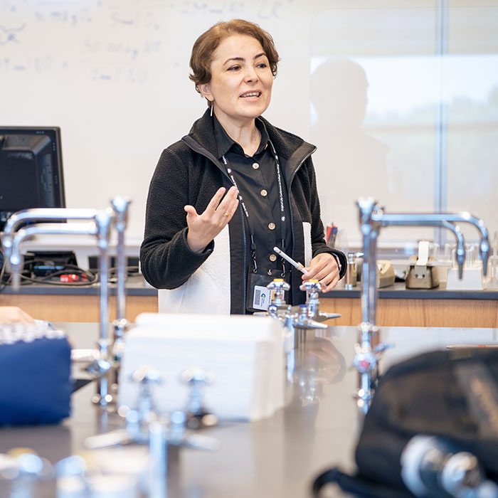 CLC instructor speaking to class in modern chemistry lab