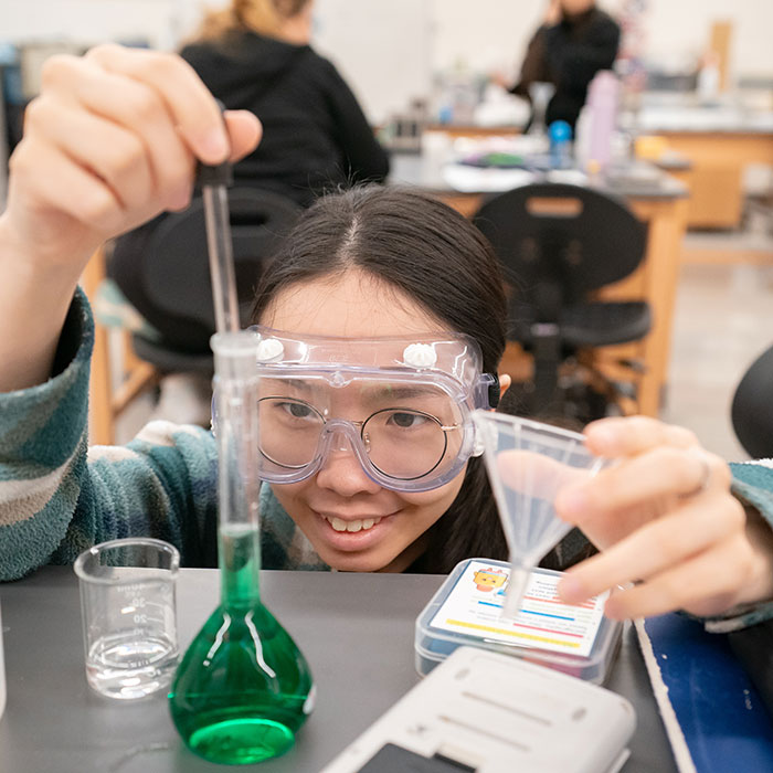 Student performing experiment in new chemistry lab