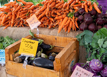 Locally-grown carrots, beets and eggplants for sale