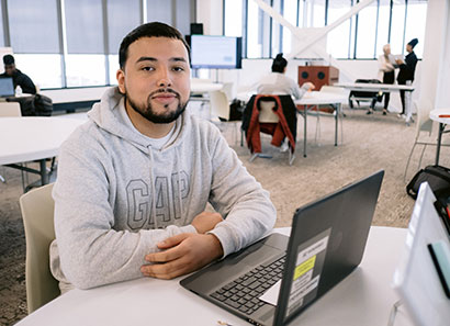 Male CLC student working on laptop computer